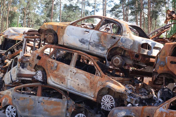 war in ukraine. Car graveyard. Shot cars of civilians. russia\'s war against Ukraine. Burnt and blown up car. Cars damaged after shelling. irpin bucha. war crimes.