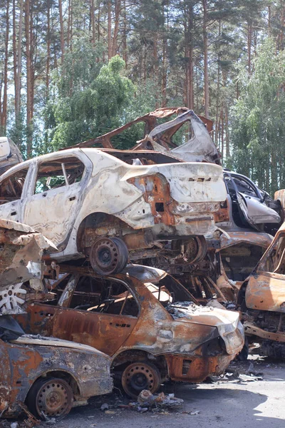 war in ukraine. Car graveyard. Shot cars of civilians. russia\'s war against Ukraine. Burnt and blown up car. Cars damaged after shelling. irpin bucha. war crimes.