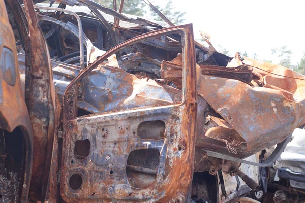 car graveyard. Burnt and blown up car. Cars damaged after shelling from russian invasion. War between Russia and Ukraine. Terror attack bomb shell. Disaster area irpin bucha.