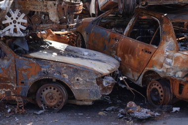 Rus ordusu ve füzesi tarafından vurulduktan sonra Irpen 'de paslı yanmış arabalar. Rusya istilası. Ukrayna 'ya karşı savaş. Savaş bölgesini boşaltmaya çalışan sivillerin tahrip edilmiş arabalarının mezarlığı..