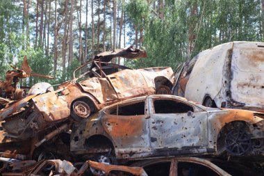 Rus ordusu ve füzesi tarafından vurulduktan sonra Irpen 'de paslı yanmış arabalar. Rusya istilası. Ukrayna 'ya karşı savaş. Savaş bölgesini boşaltmaya çalışan sivillerin tahrip edilmiş arabalarının mezarlığı..