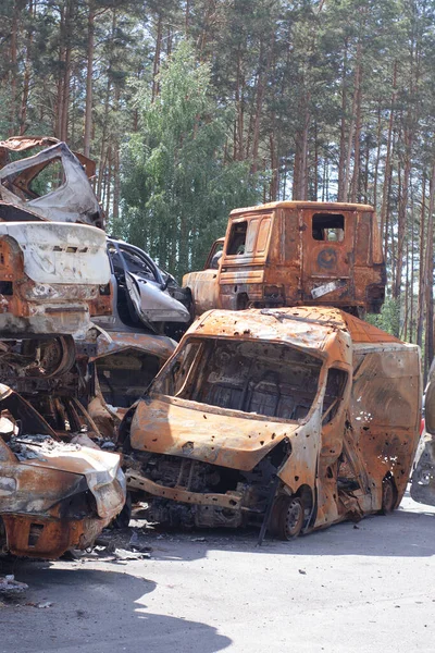 car graveyard. Burnt and blown up car. Cars damaged after shelling from russian invasion. War between Russia and Ukraine. Terror attack bomb shell. Disaster area irpin bucha.