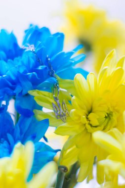 Mavi ve sarı kasımpatıların arka planında Ukrayna sembolü mızrak. Ukrayna 2022 'de savaş. Ukrayna 'nın devlet arması. Ukrayna 'nın sembolü