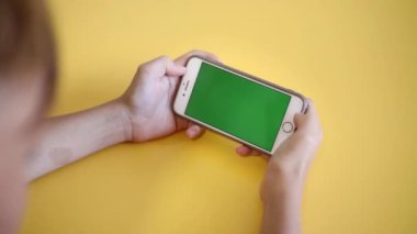 Child Using Phone With Green Mock-up. Surfing Internet Watching Content Videos Blogs Learning. boy Playing Video Games. chroma key for copy space. Slow motion.