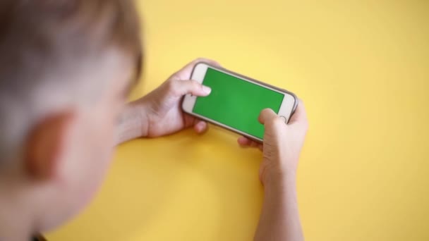 Teenager Holding Smartphone Hands Green Screen Keying Shoulder View Back — Stok Video