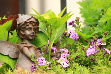 Flower-bed mit an angel statue clipart