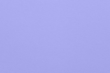 Close-up of rough textured grooved designer paper surface with horizontal small parallel grooves. Full frame background toned in very peri, color of year 2022. . Copy space. Horizontal orientation.