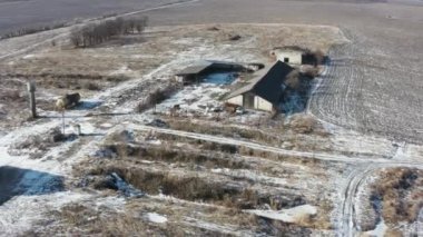 İflas etmiş çiftliğin terk edilmiş ahırlarının üstündeki hava üssü. Ekonomik kriz, verimsiz yönetim veya iflas