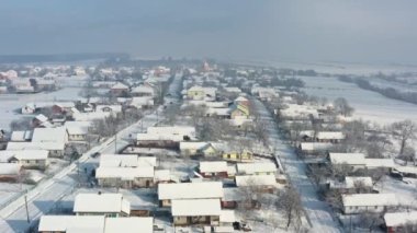 Kış manzaralı hava manzarası. Pencerenin dışında kar var. Beyaz karla kaplı evler. Kış mevsimi