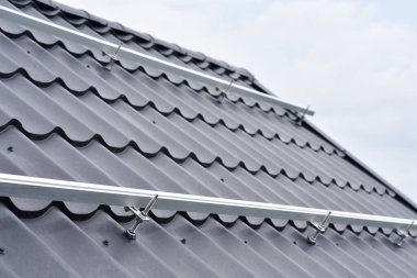 Brackets solar panel mounting system. Process of mounting solar power system on the roof. Turnkey solar power system, service works. Green energy. Rooftop solar power system