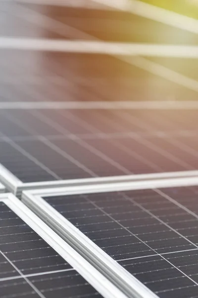 Black solar panels, close up view. Small drops of water on the surface of the panels after rain. Industrial background with copy space.