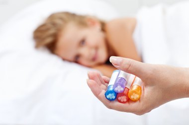 Little girl awaiting homeopathic medication clipart