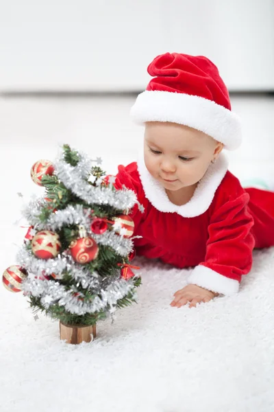 My first christmas - baby girl with small decorated tree — Stock Photo, Image
