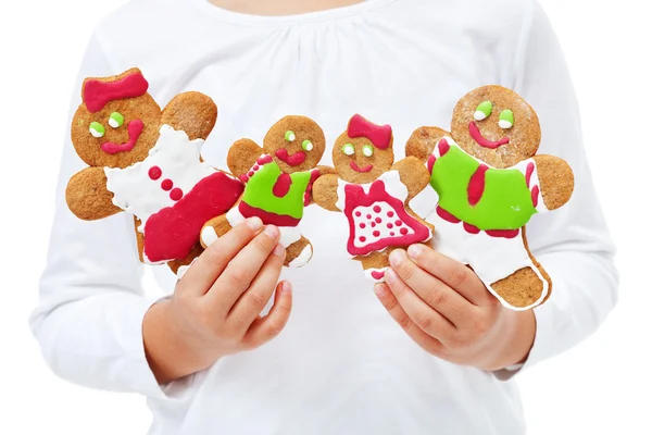 Child hands with happy gingerbread family — Stock Photo, Image