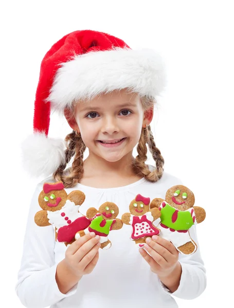 Glückliches kleines Mädchen mit Lebkuchenfamilie — Stockfoto