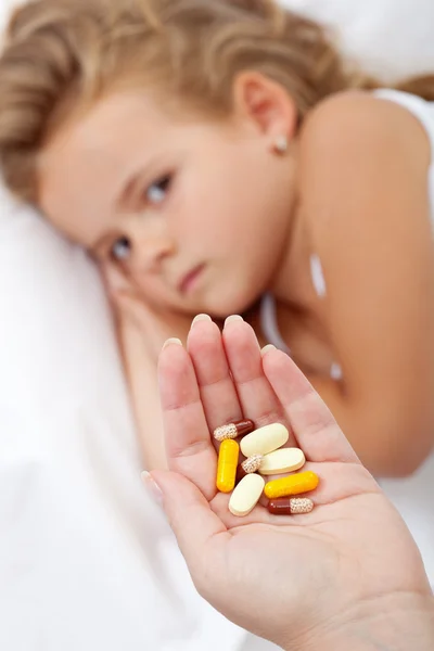 Lots of pills for a sick little girl — Stock Photo, Image