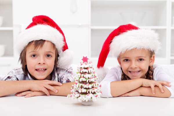 Kids at christmas time with gingerbread tree