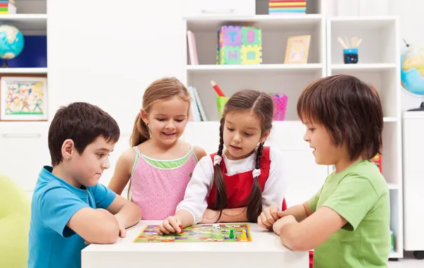 Kids playing board game in their room — Stock Photo, Image