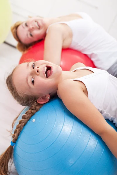 Happy exercising - little girl and her mother — Stock Photo, Image