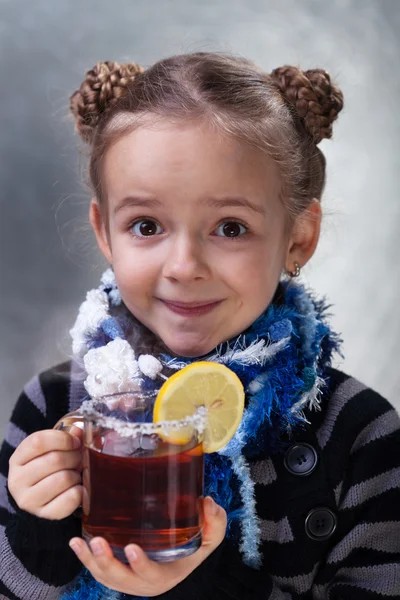 Little girl with large cup of tea — Stock Photo, Image