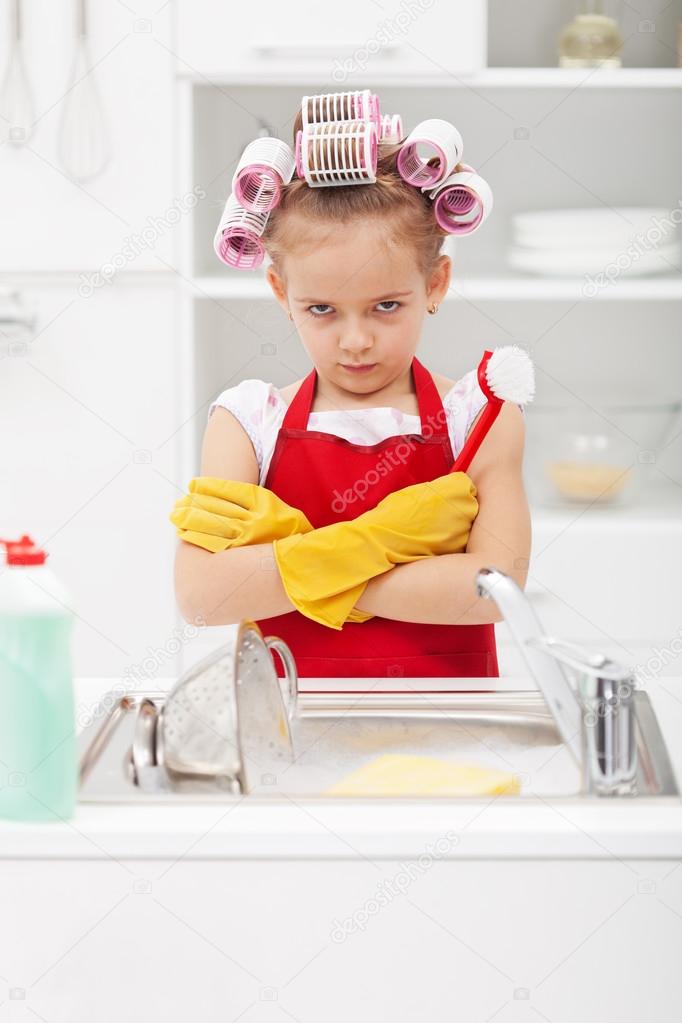 Grumpy little girl washing dishes