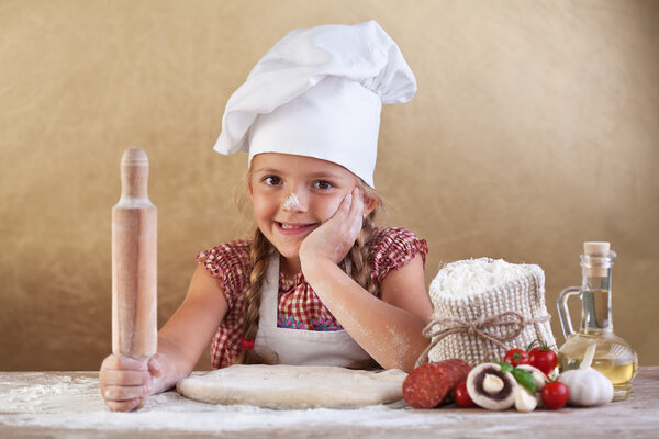 Little girl making pizza