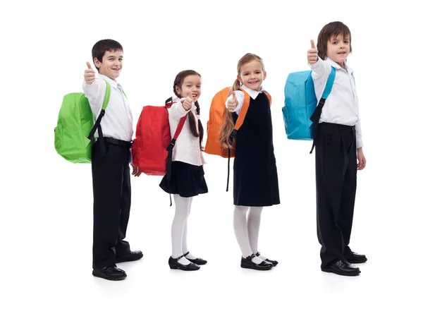 Ritorno a scuola concetto con i bambini felici dando pollice su segno Foto Stock Royalty Free