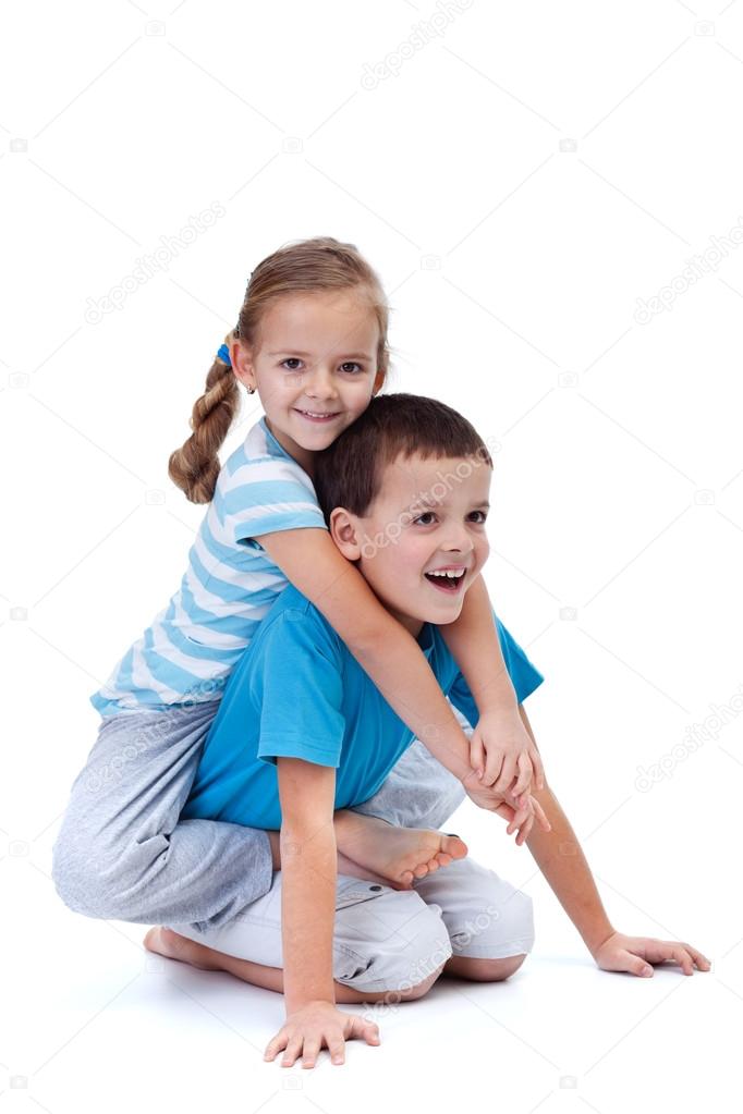 Happy kids playing and wrestling on the floor