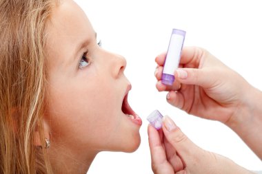 Young girl taking homeopathic medicine clipart