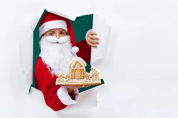 Papai Noel dando-lhe uma casa de biscoitos de gengibre — Fotografia de Stock