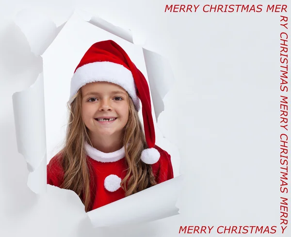 Happy little santa girl with teeth missing, smiling through hole — Stock Photo, Image