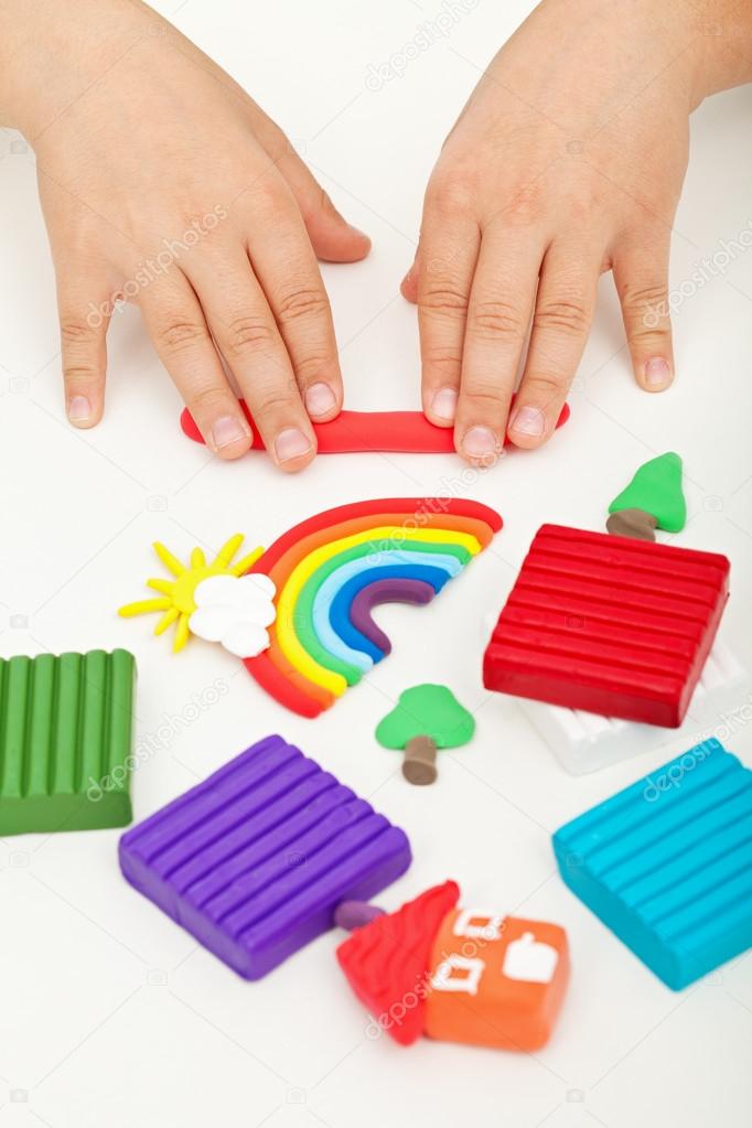 Child hands playing with modeling clay