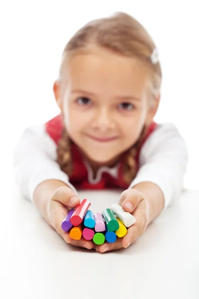 Happy little girl holding colorful modelling clay bars — Stock Photo, Image