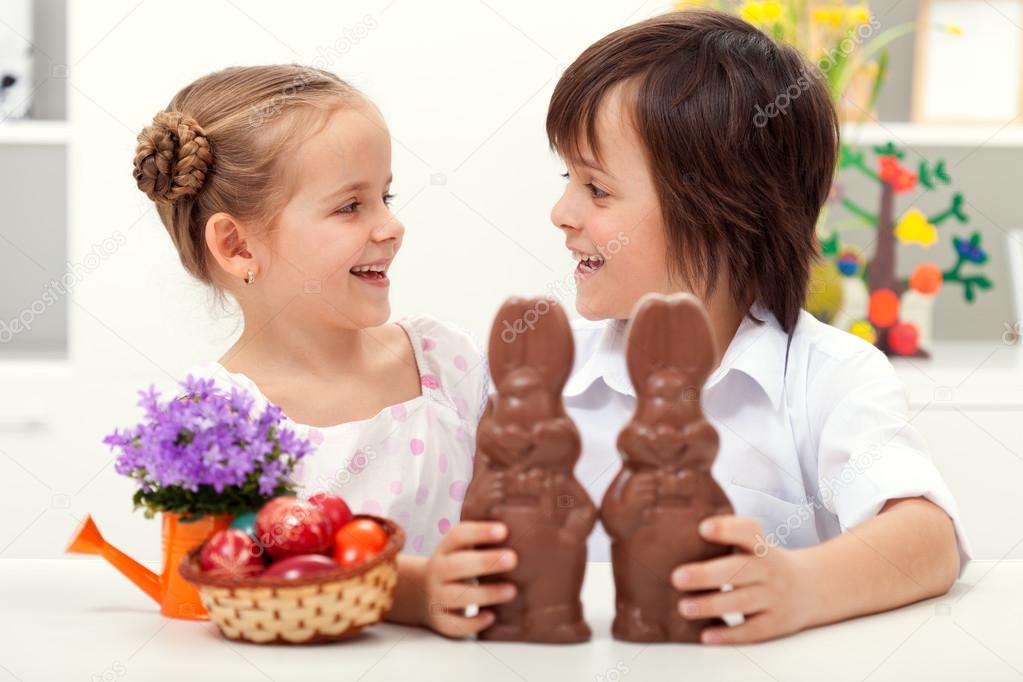 Happy kids at easter time with large chocolate bunnies