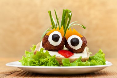 Funny meatball sandwich with vegetables clipart