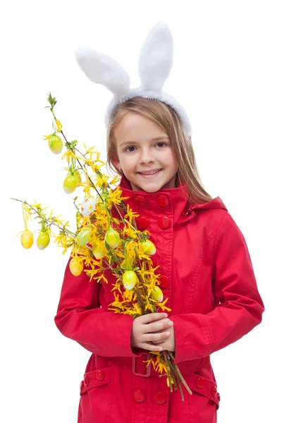 Little girl in spring clothes and flower branch — Stock Photo, Image