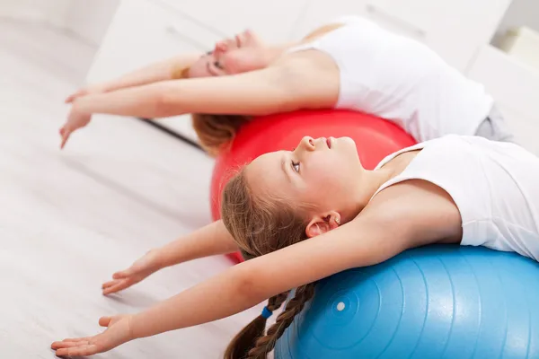 Woman and little girl exercising — Stock Photo, Image