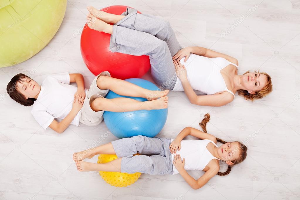 Family relaxing after gymnastic exercise