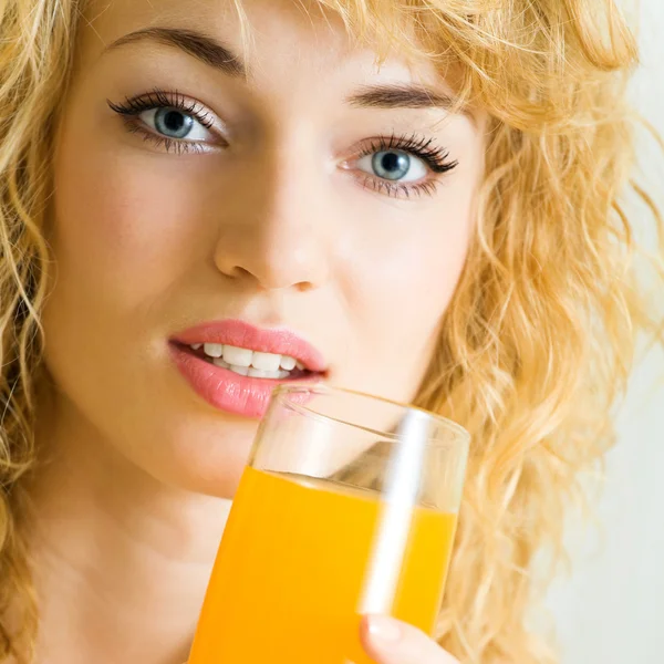Happy woman drinking juice — Stock Photo, Image
