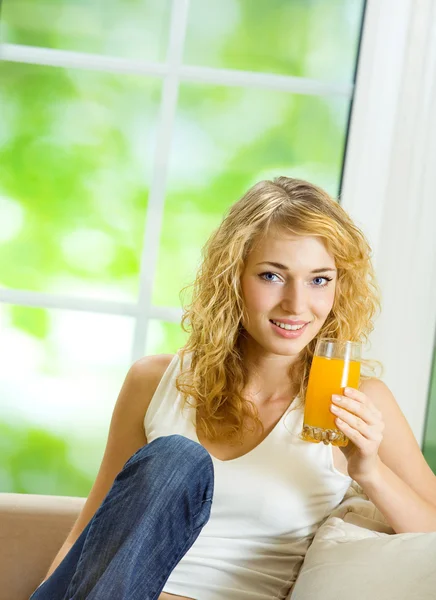 Happy woman drinking juice — Stock Photo, Image