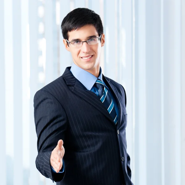 Young businessman giving hand for handshake — Stock Photo, Image