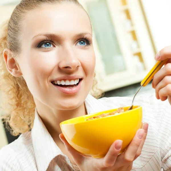 Wesoły kobieta jedzenie zbóż muślinu — Zdjęcie stockowe