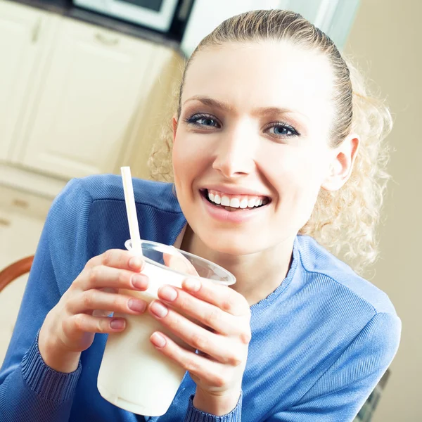 Cheerful woman drinking milk Stock Photo
