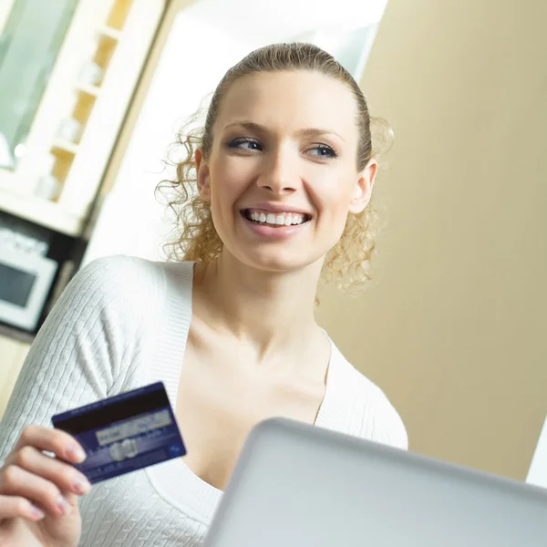 Cheerful woman paying by plastic card Stock Photo