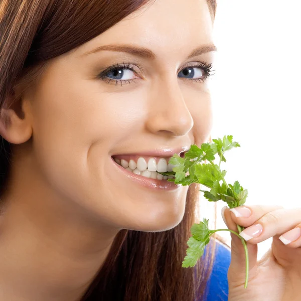 Mujer alegre comiendo potherbs, sobre blanco — Foto de Stock