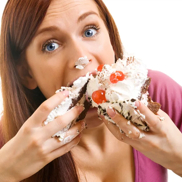 Mujer alegre comiendo pastel, sobre blanco — Foto de Stock