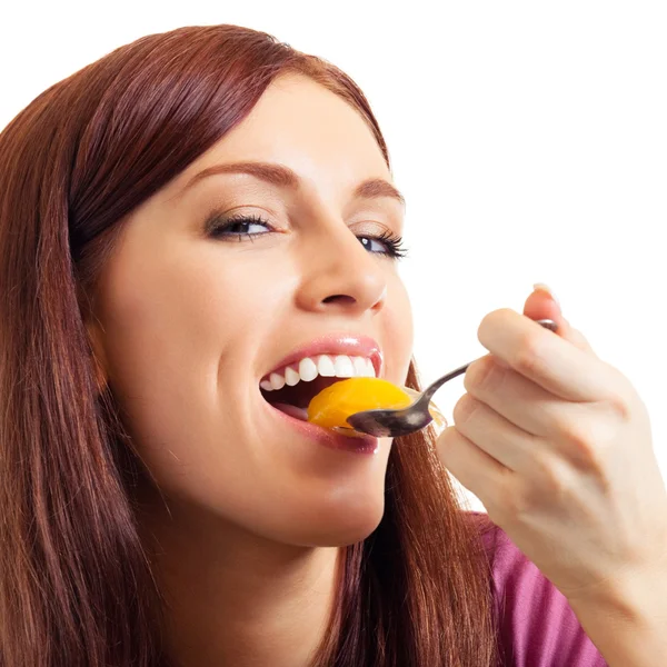 Cheerful beautiful woman eating apricots — Stock Photo, Image