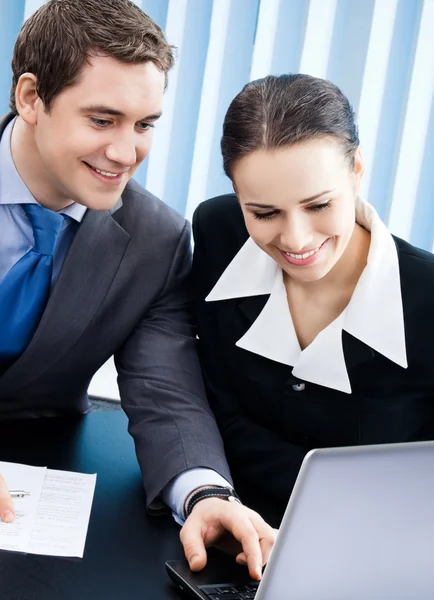 Businesspeople working with laptop at office Stock Photo