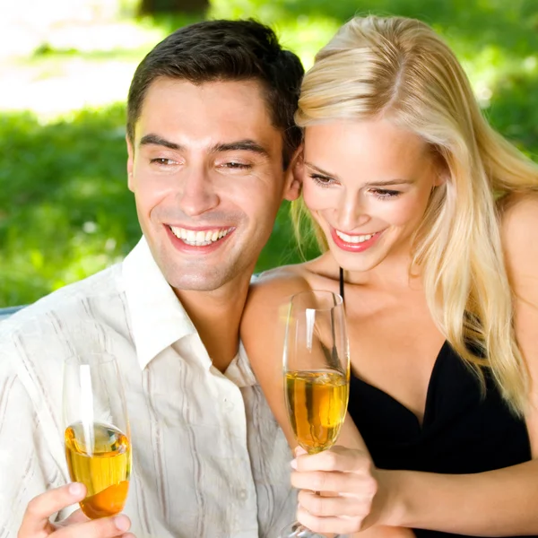 Young happy couple with champagne, outdoor Stock Picture