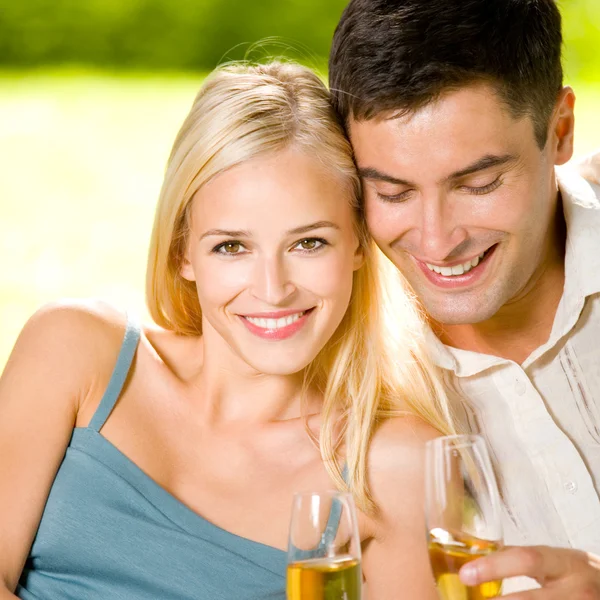 Young happy couple with champagne, outdoor Stock Image